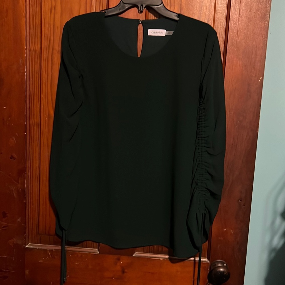 Dark green Calvin Klein shirt. Almost Positive it’s a large but the size tag